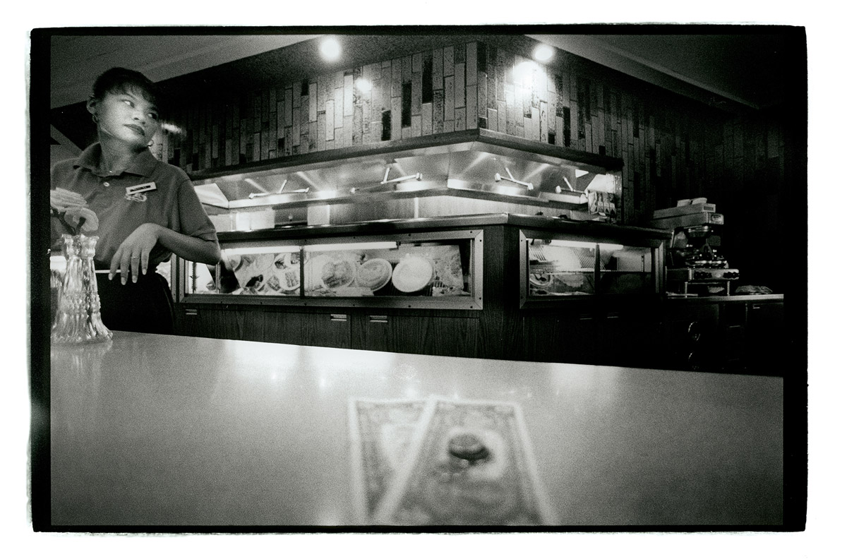 Across Wilmington Avenue from the big Arco refinery, Bernice X works weekends and evenings behind the counter